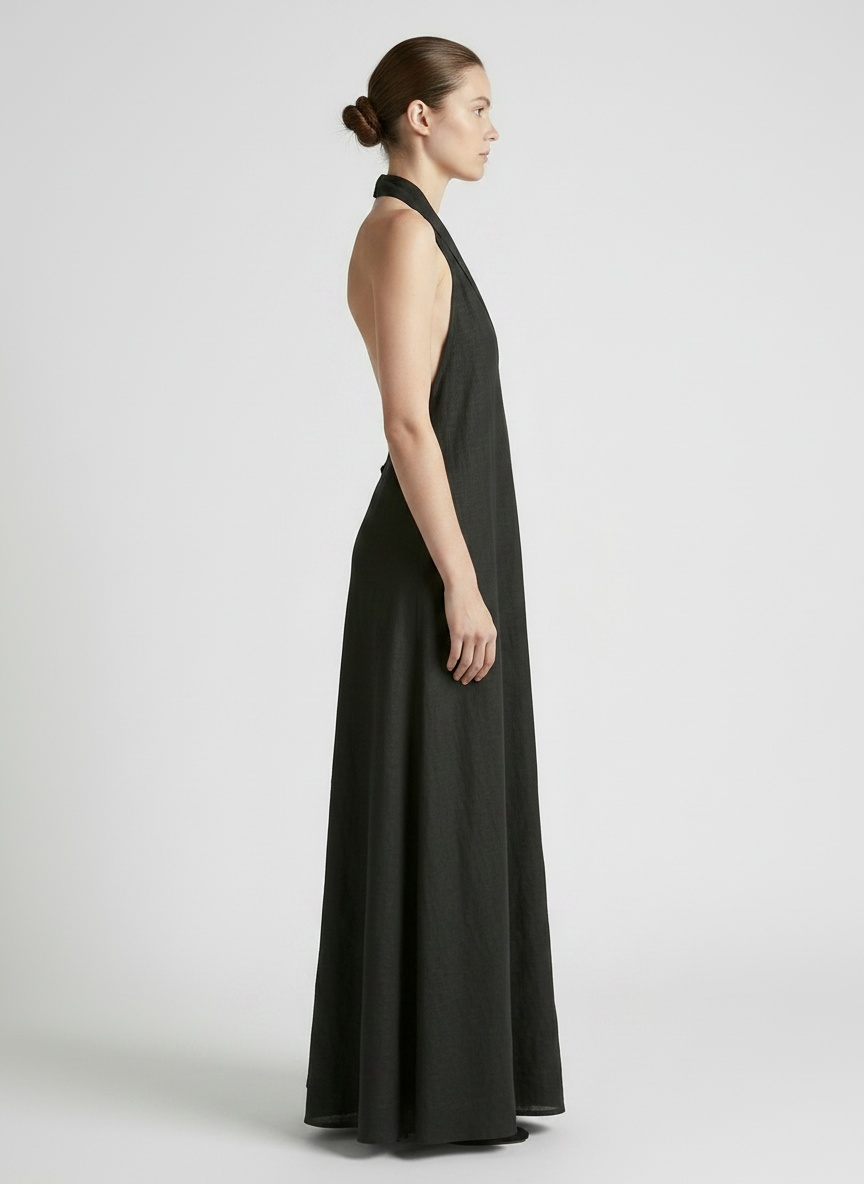 Woman wearing a black halter neck dress on a white background