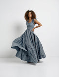 Woman wearing a blue checkered dress on a white background