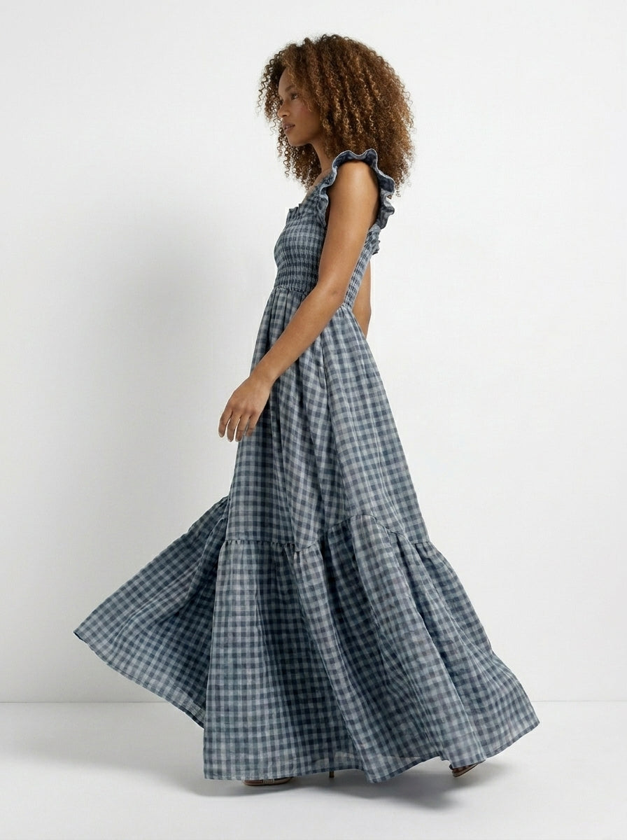 Woman wearing a blue checkered dress on a white background