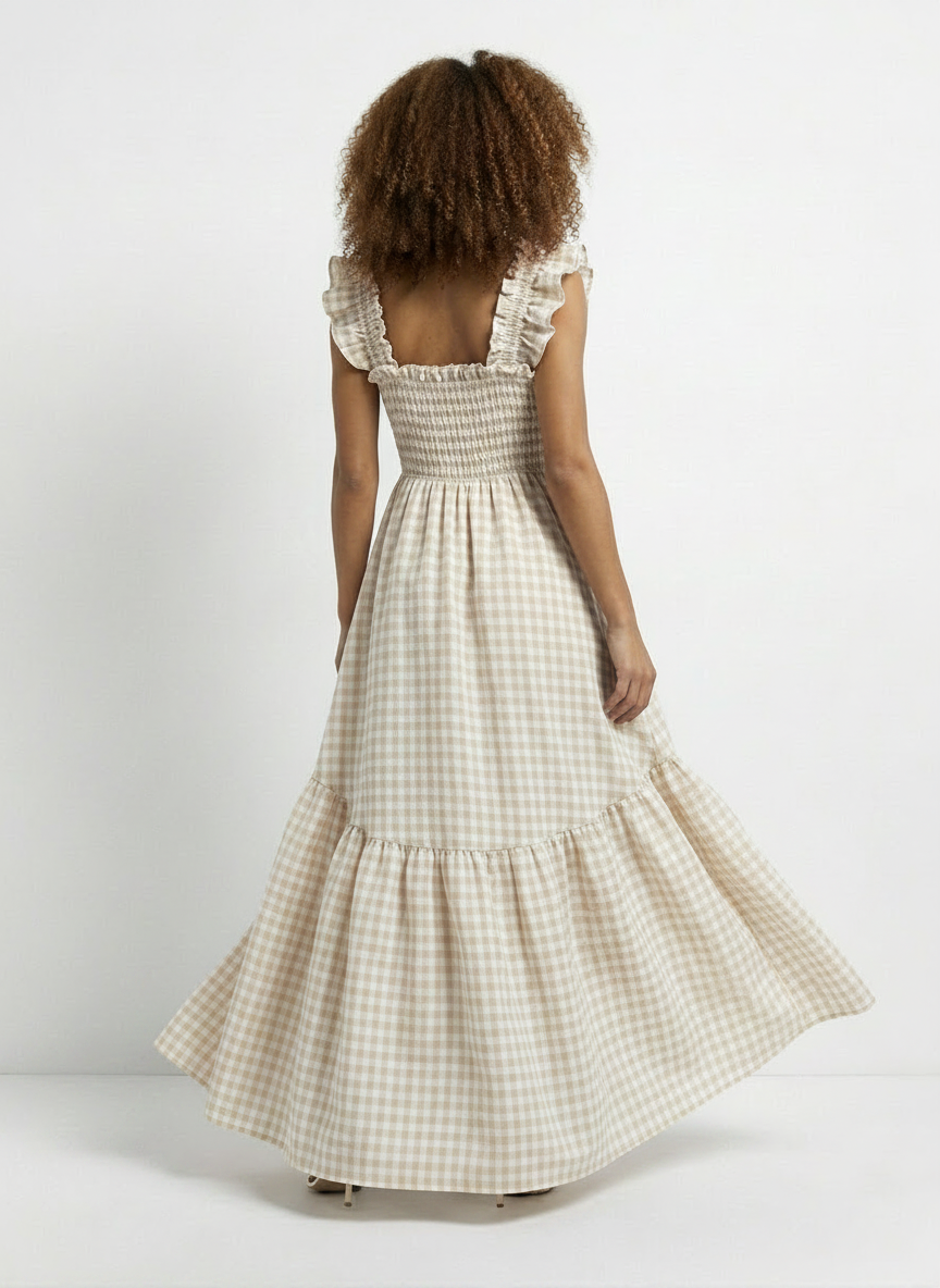 Woman wearing a checkered dress with ruffled sleeves on a white background