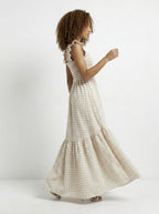 Woman wearing a checkered dress on a white background