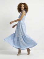 Woman wearing a blue checkered dress on a white background