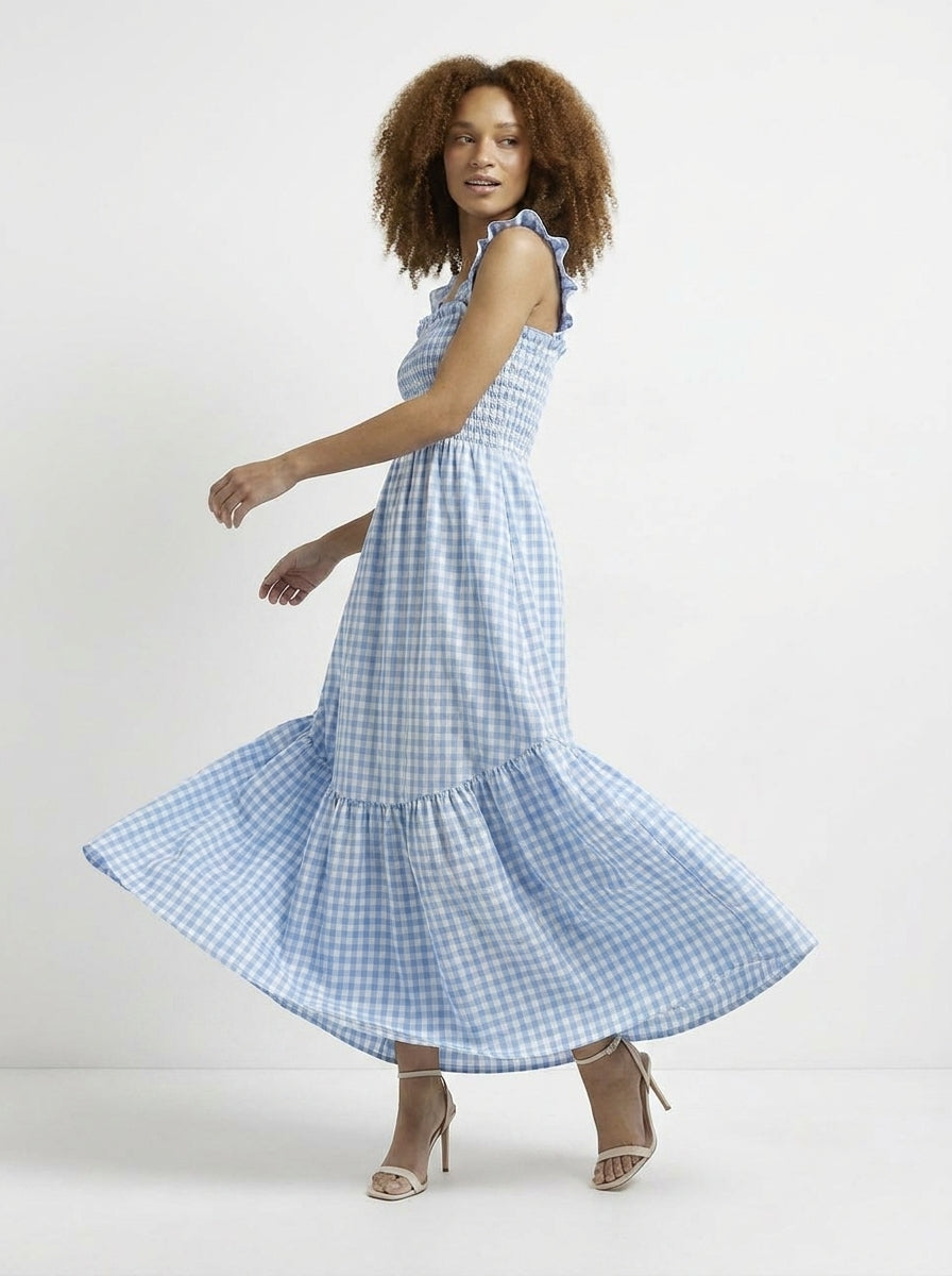 Woman wearing a blue checkered dress on a white background
