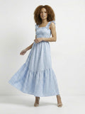 Woman wearing a blue checkered dress on a white background