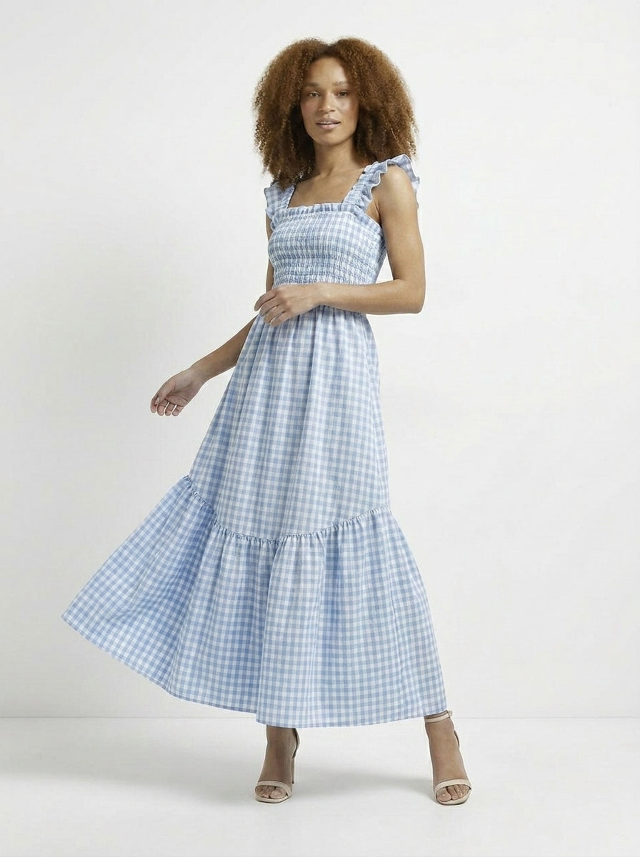 Woman wearing a blue checkered dress on a white background