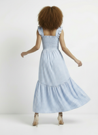 Woman wearing a blue checkered dress on a white background