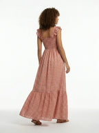 Woman wearing a red checkered dress on a white background