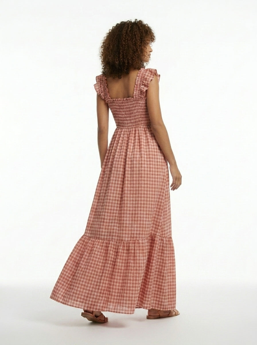 Woman wearing a red checkered dress on a white background