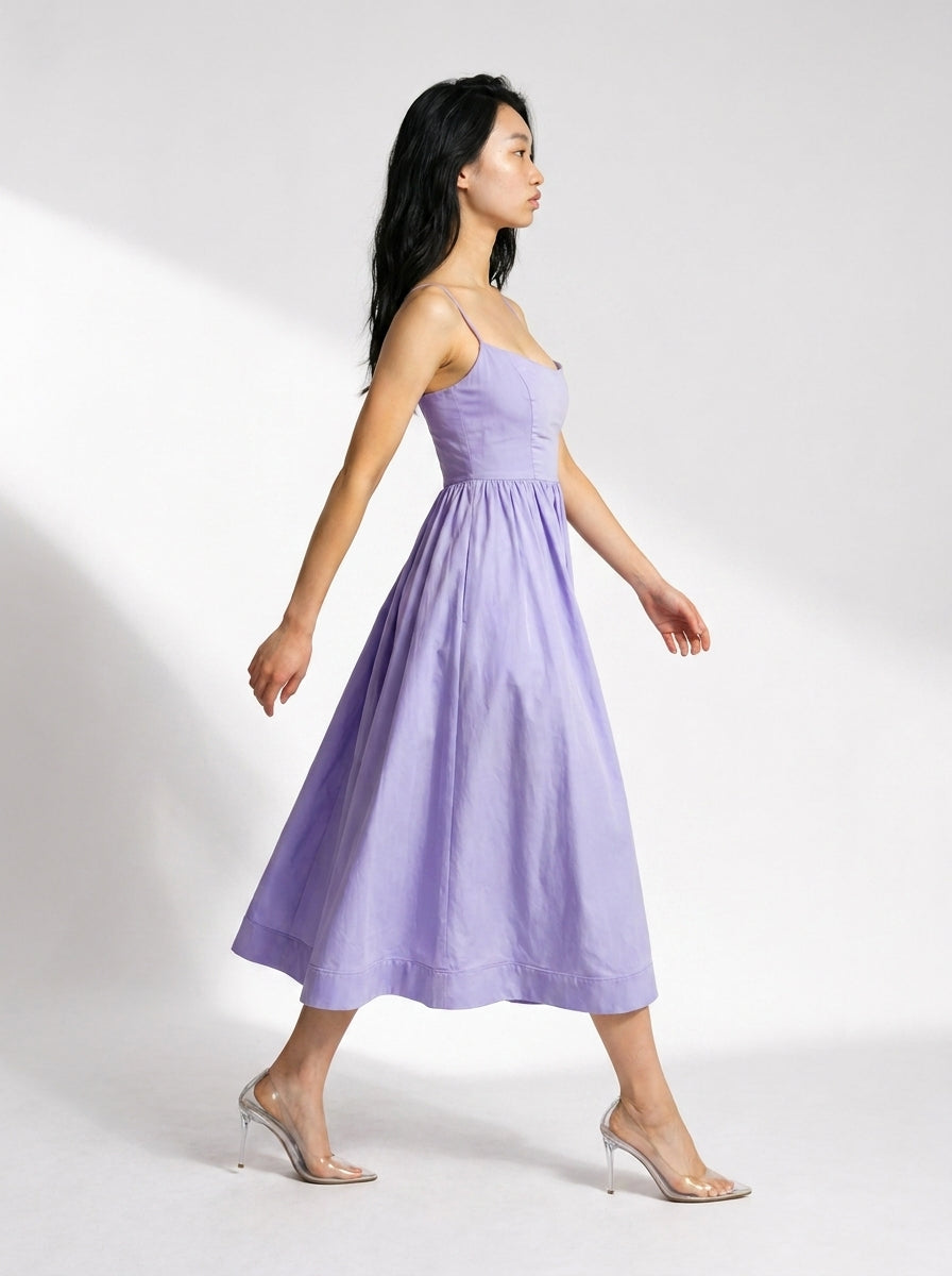 Woman wearing a light purple strapless dress on a white background