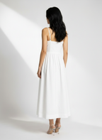 Woman wearing a white dress against a white background