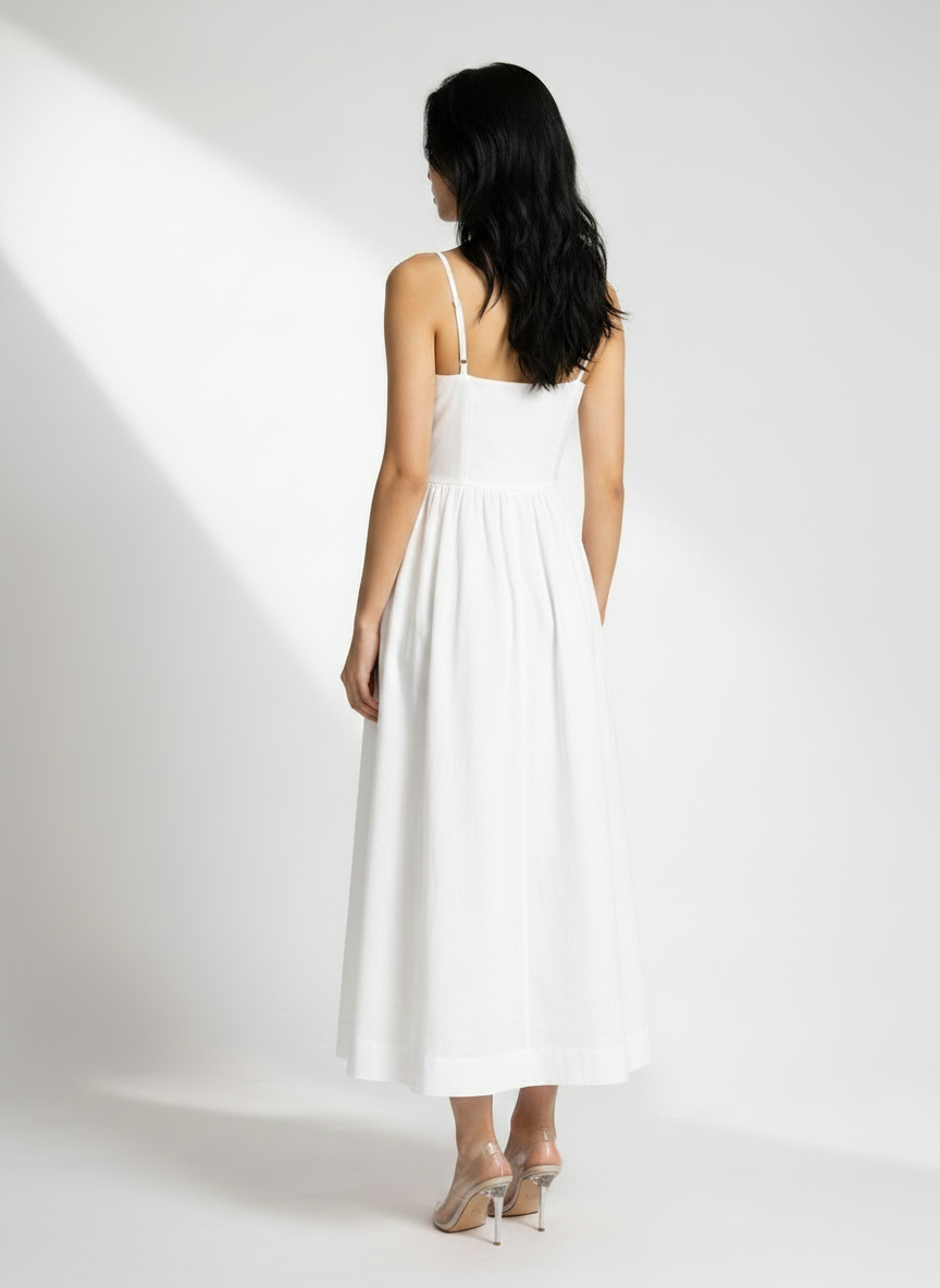 Woman wearing a white dress against a white background