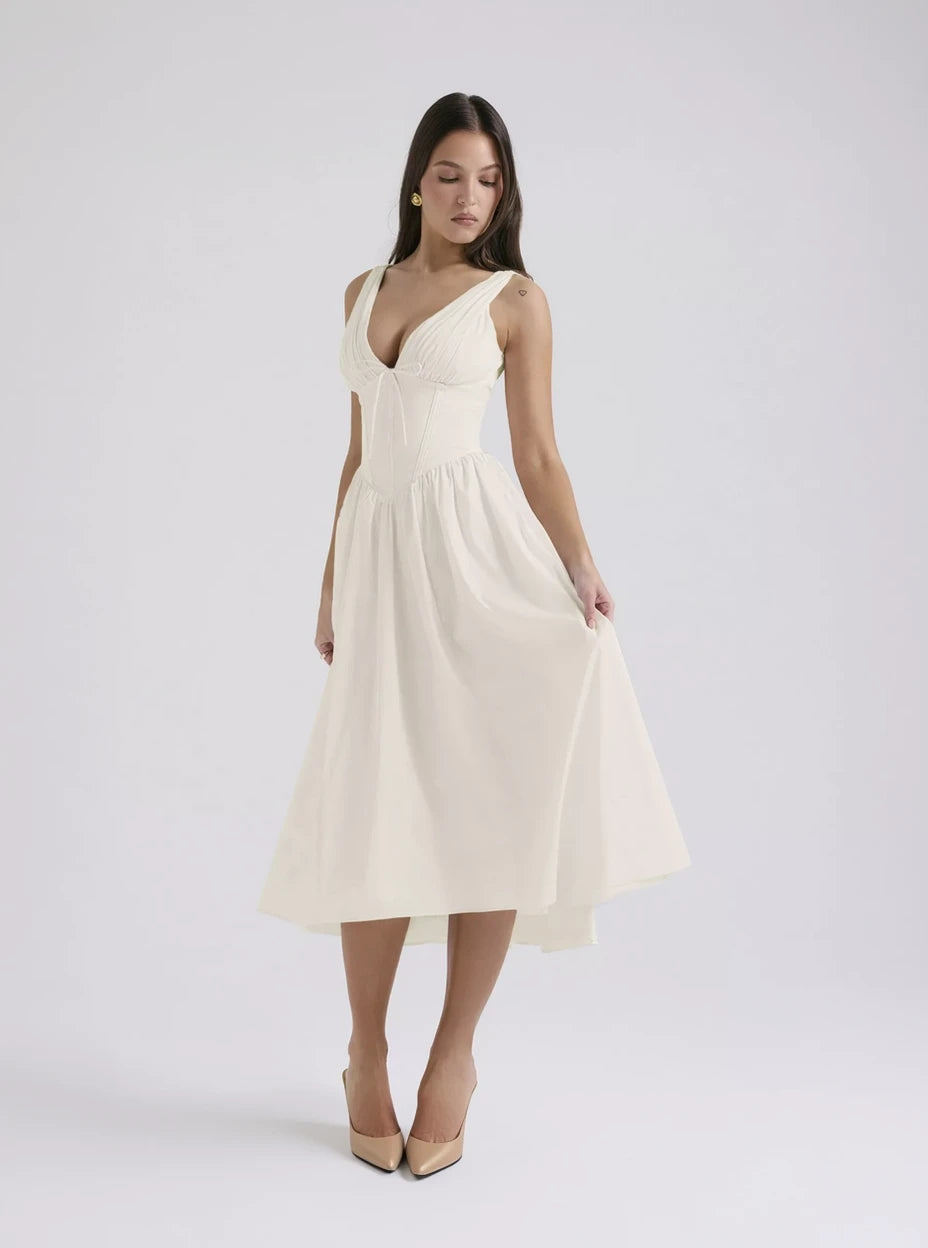 Woman wearing a white dress on a plain background