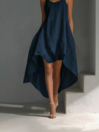Navy blue dress with a high-low hem on a gray background