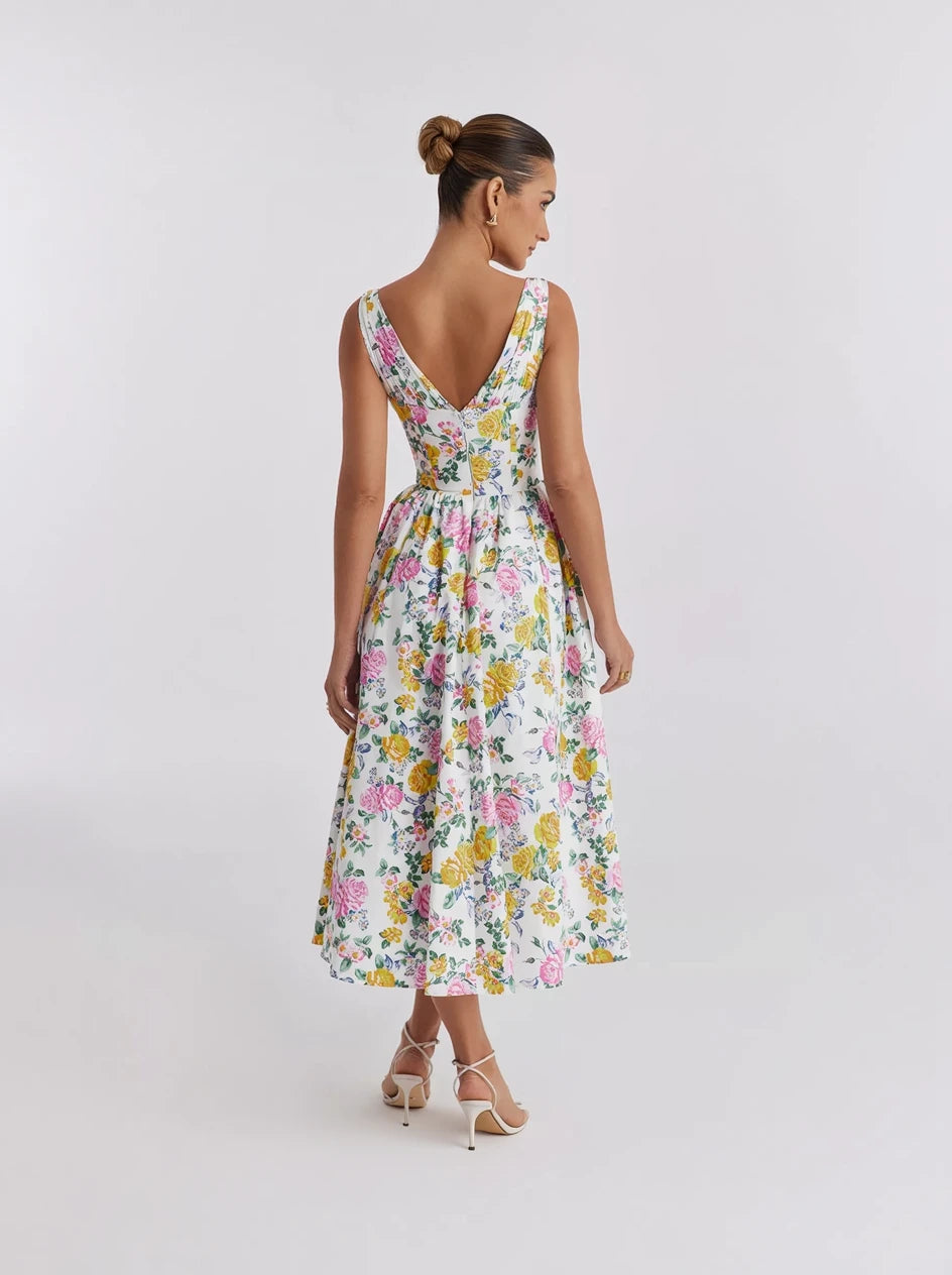 Woman wearing a floral dress on a plain background